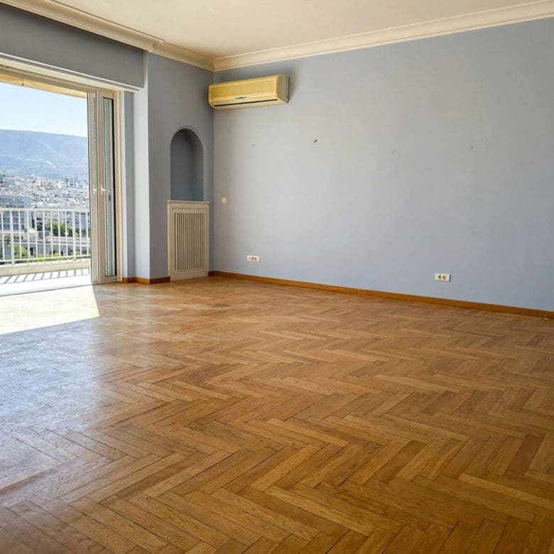 Spacious empty living room with wood flooring and large balcony doors, Anaktora, Kolonaki, Athens, Greece