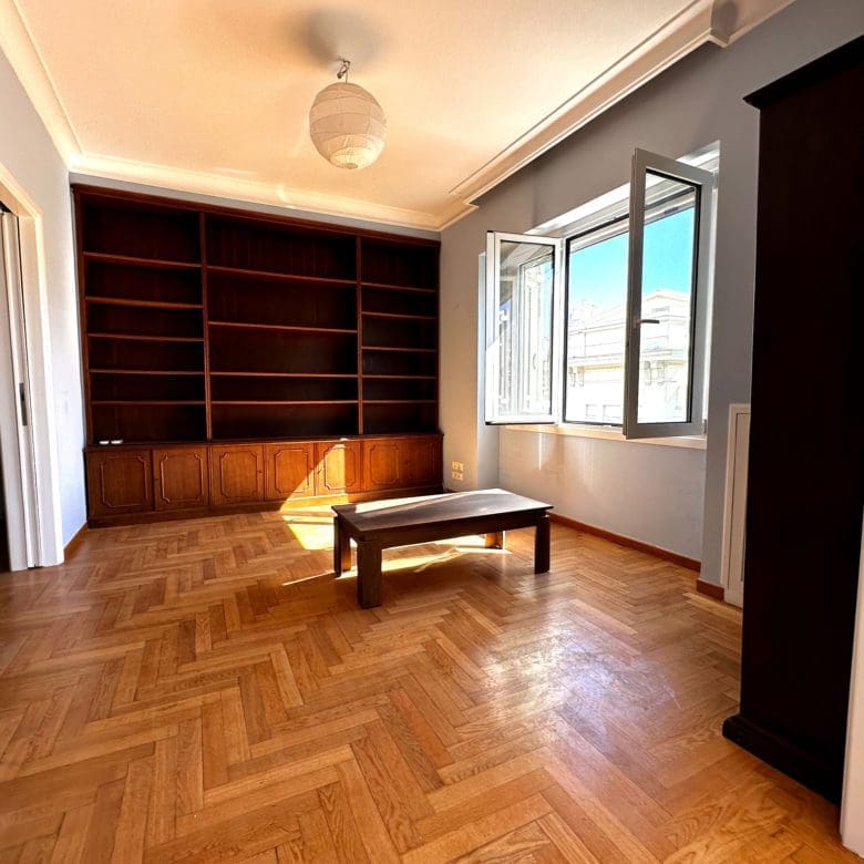 Room view with built-in shelving, wood flooring, and doorway connection, Anaktora, Kolonaki, Athens, Greece
