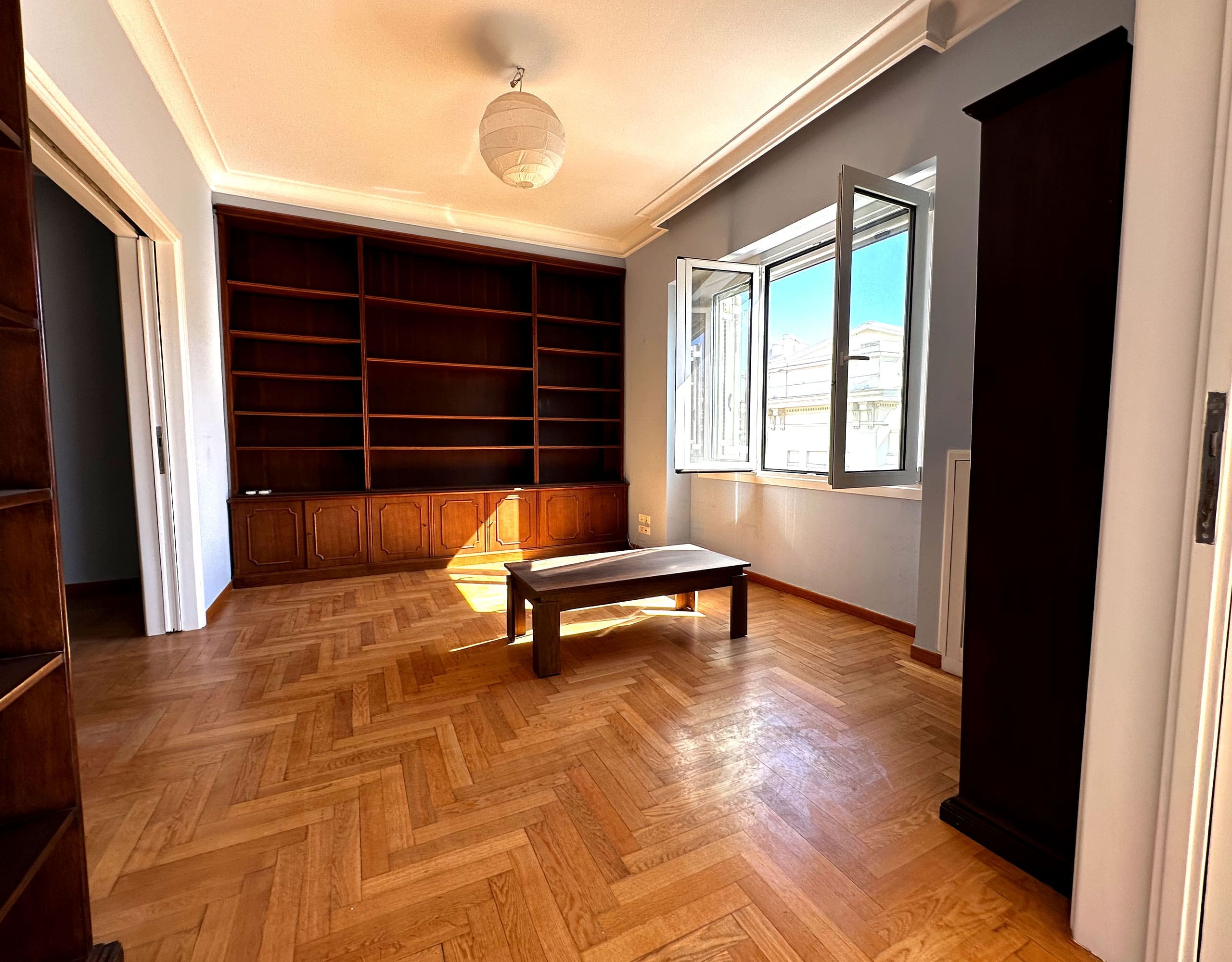 Room view with built-in shelving, wood flooring, and doorway connection, Anaktora, Kolonaki, Athens, Greece