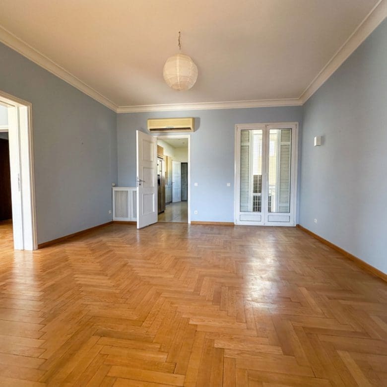 Spacious empty room with wood flooring and doorway to the hallway, Anaktora, Kolonaki, Athens, Greece