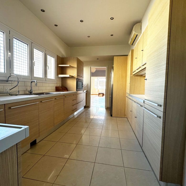 Kitchen counter and sink area with wood cabinets and tiled floor, Anaktora, Kolonaki, Athens, Greece