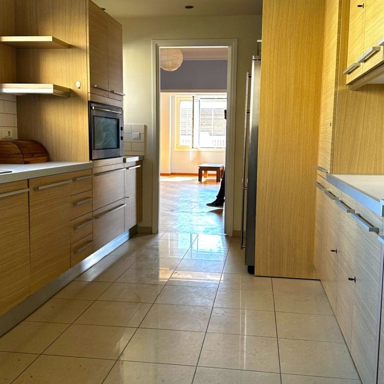 Galley kitchen view with wood cabinetry and corridor layout, Anaktora, Kolonaki, Athens, Greece