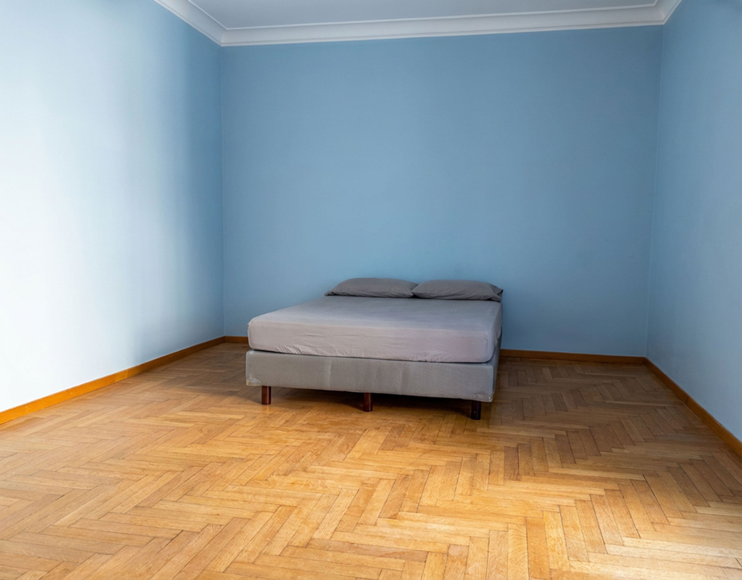 Empty bedroom with wood flooring and blue walls, Anaktora, Kolonaki, Athens, Greece