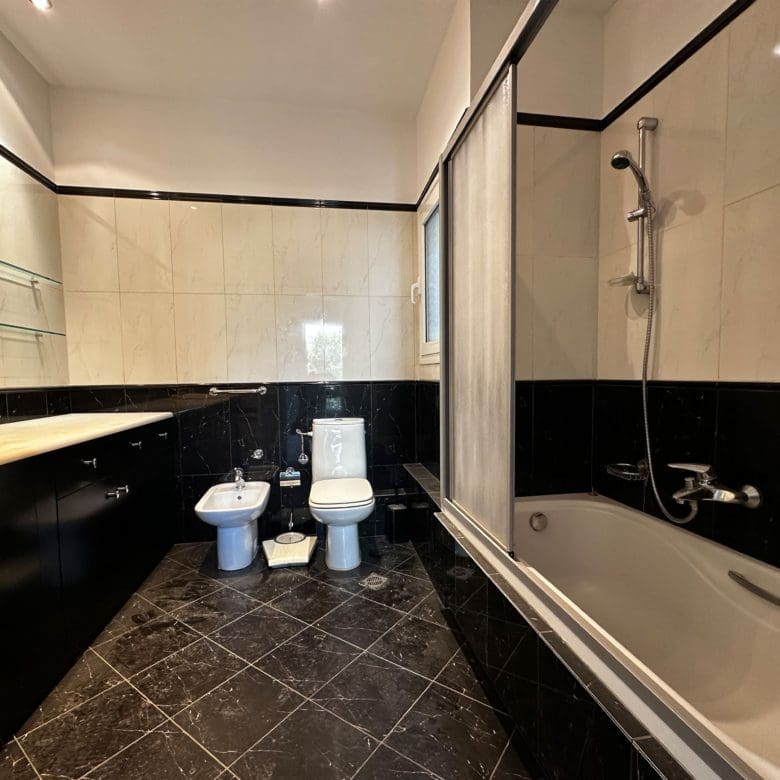Bathroom with bathtub, bidet, and black-and-white tile finishes, Anaktora, Kolonaki, Athens, Greece