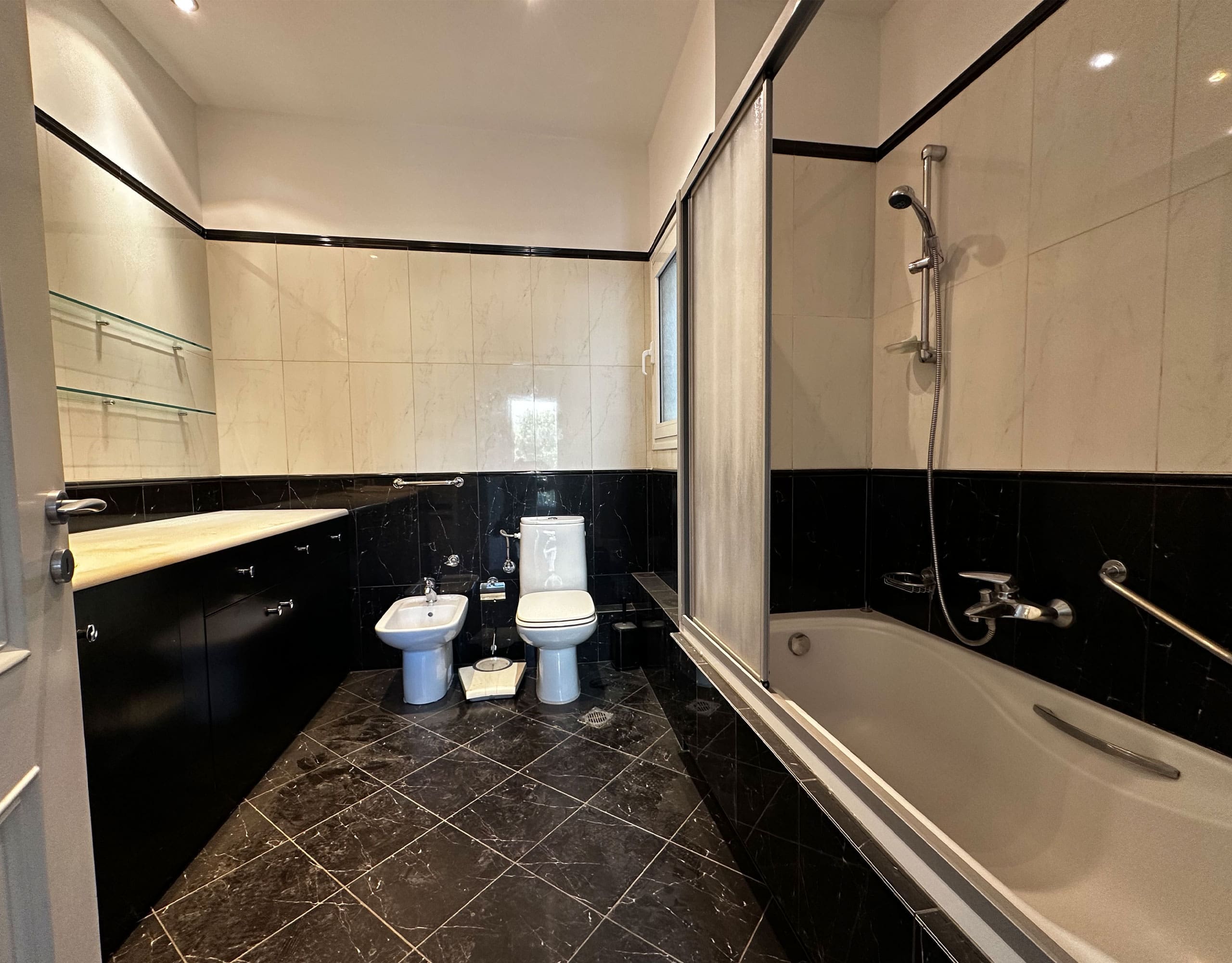 Bathroom with bathtub, bidet, and black-and-white tile finishes, Anaktora, Kolonaki, Athens, Greece