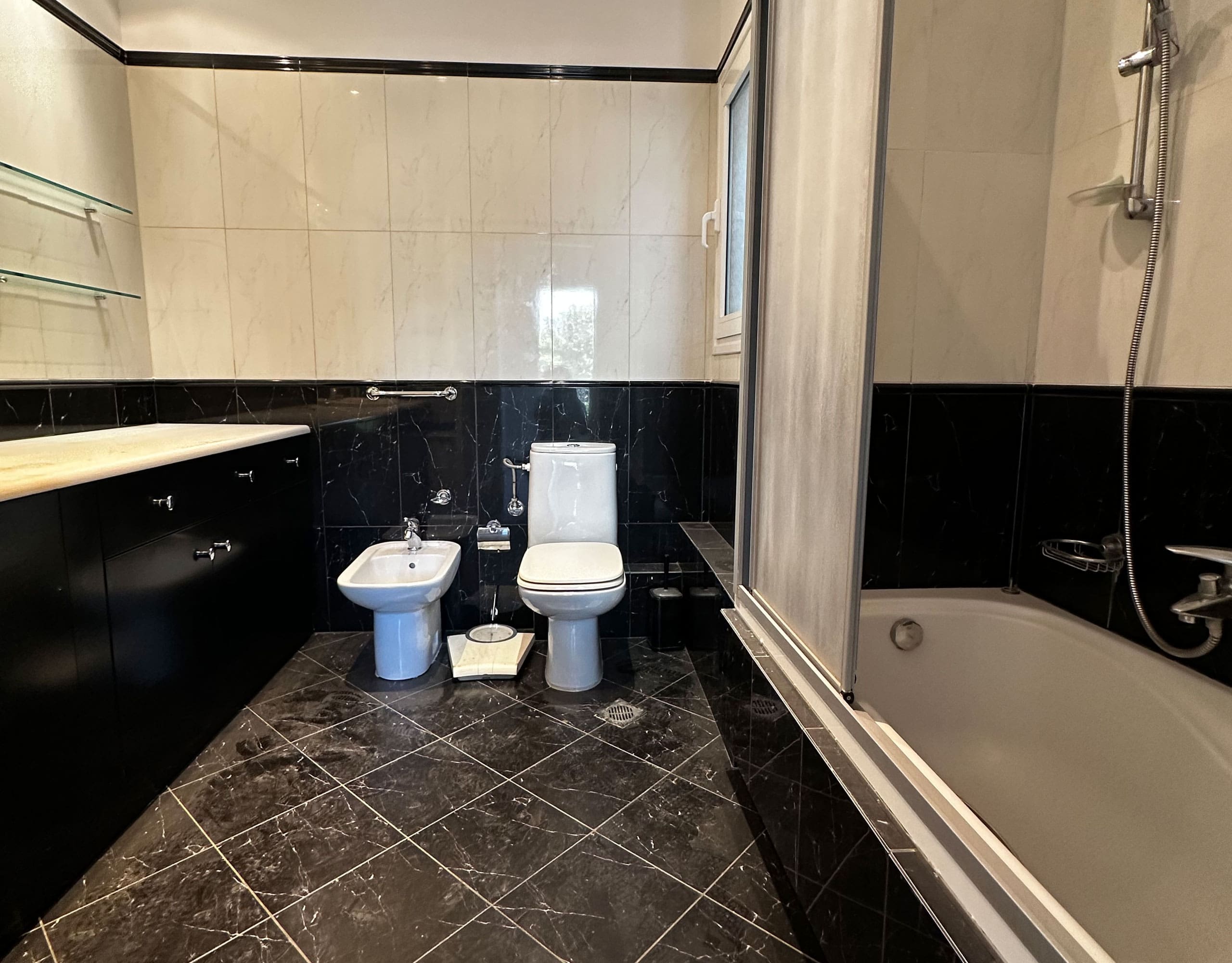 Bathroom bathtub area with black tile floor and white wall tiles, Anaktora, Kolonaki, Athens, Greece