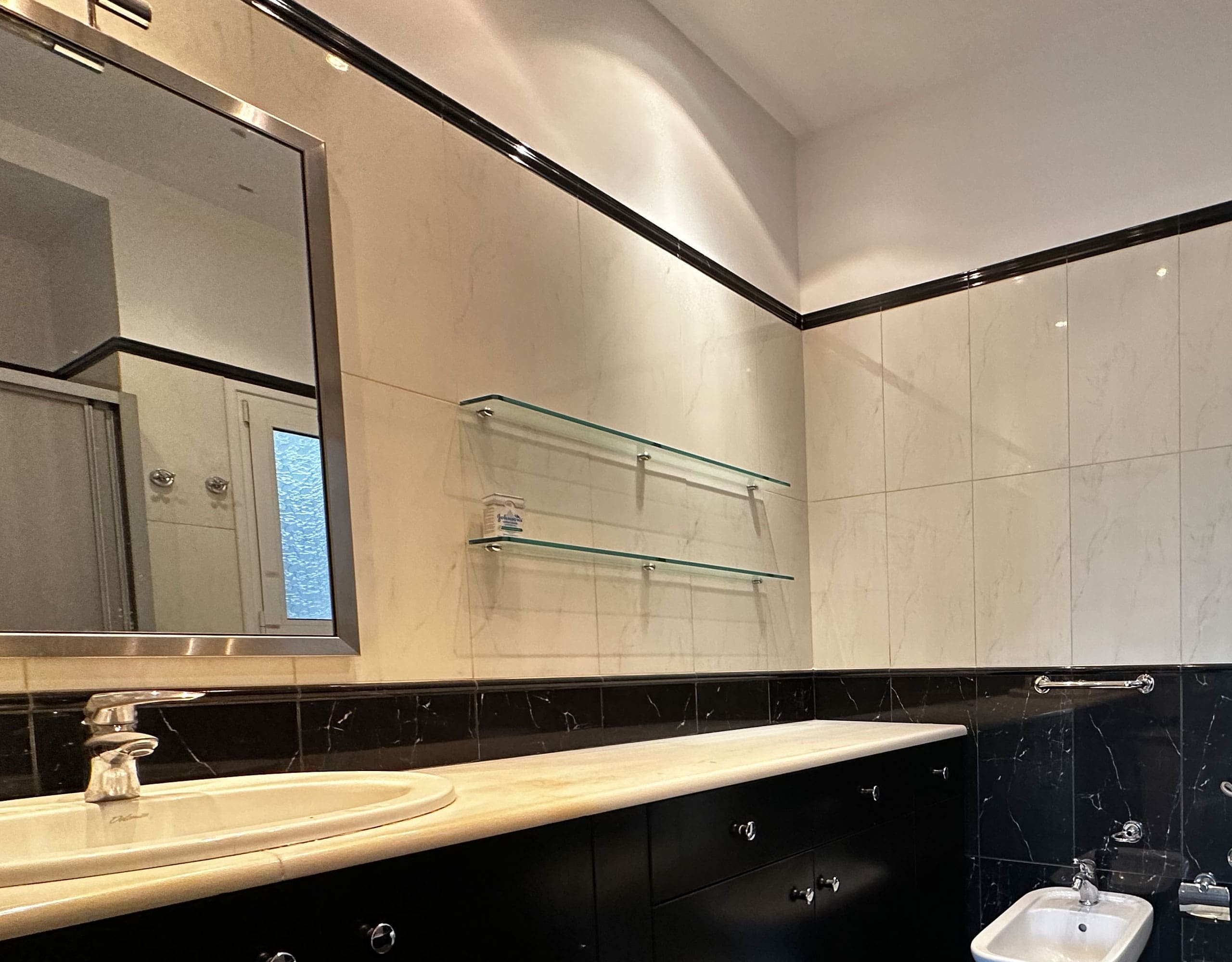 Bathroom vanity and mirror with black-and-white tile finishes, Anaktora, Kolonaki, Athens, Greece
