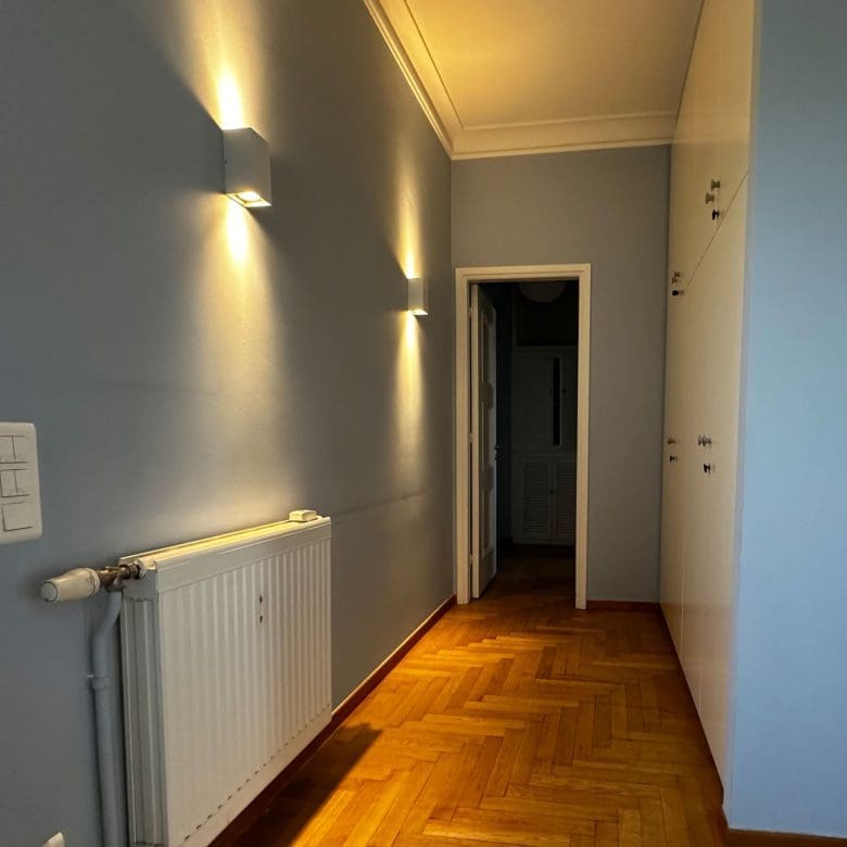 Interior hallway with wood flooring and wall lighting, Anaktora, Kolonaki, Athens, Greece