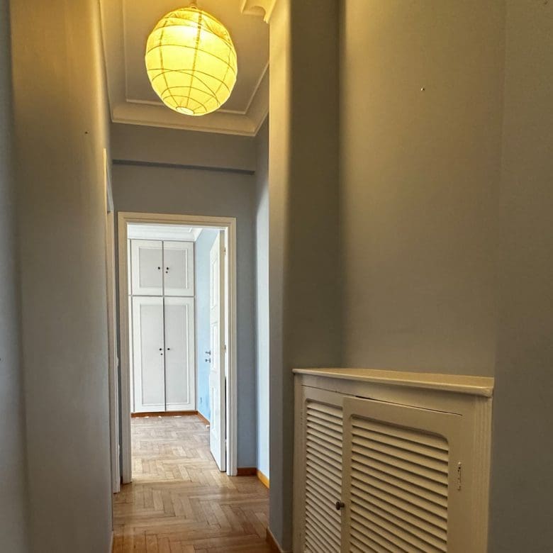 Interior hallway with wood flooring, radiator cover, and ceiling light, Anaktora, Kolonaki, Athens, Greece