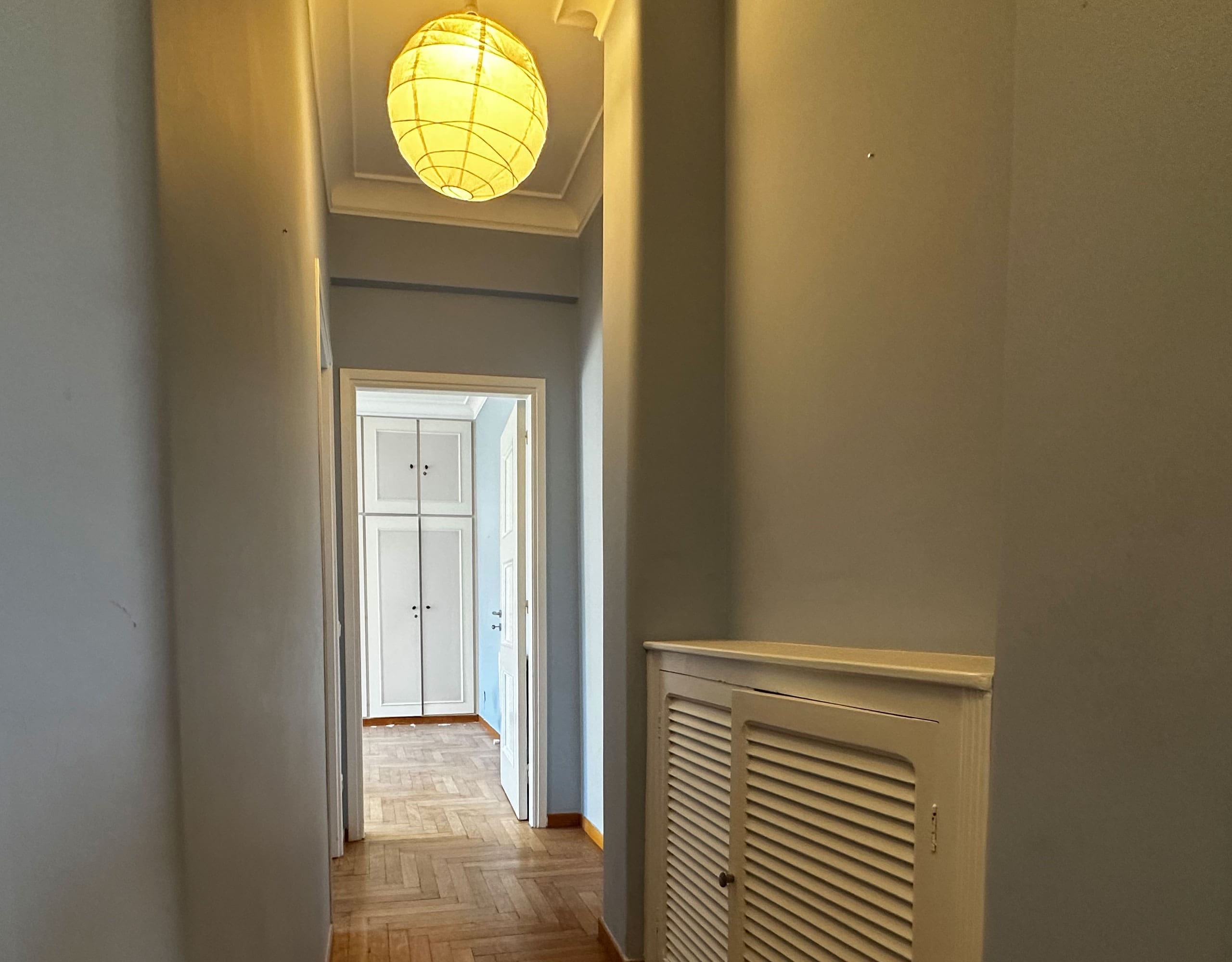 Interior hallway with wood flooring, radiator cover, and ceiling light, Anaktora, Kolonaki, Athens, Greece