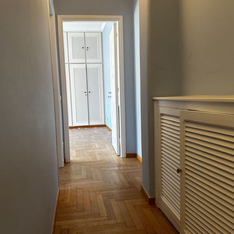 Hallway view with wood flooring and radiator cover detail, Anaktora, Kolonaki, Athens, Greece