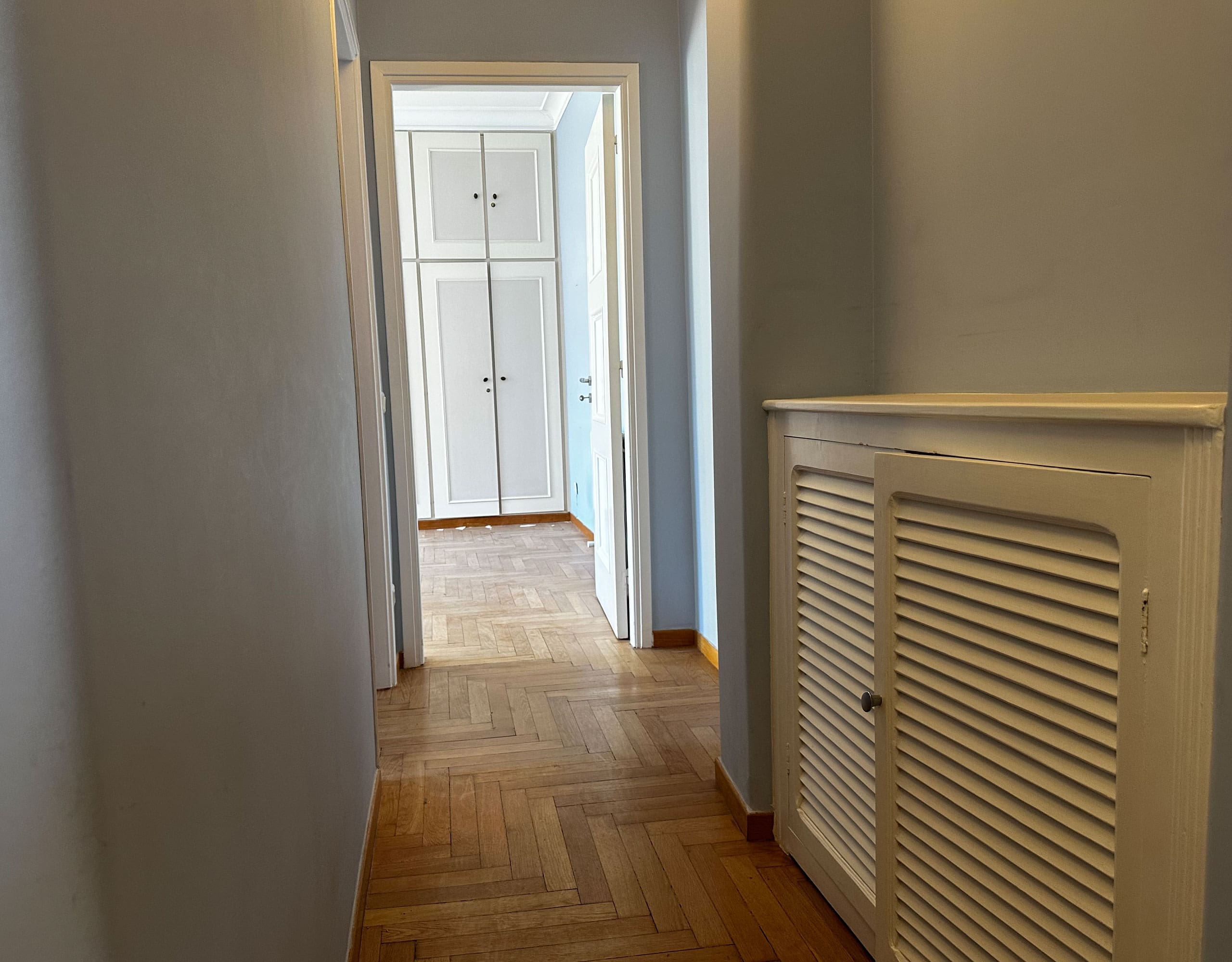 Hallway view with wood flooring and radiator cover detail, Anaktora, Kolonaki, Athens, Greece