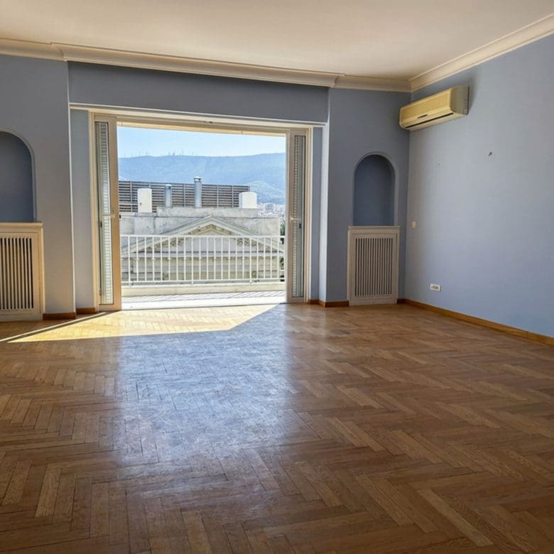 Bright living room with wood flooring and large balcony doors with city views, Anaktora, Kolonaki, Athens, Greece