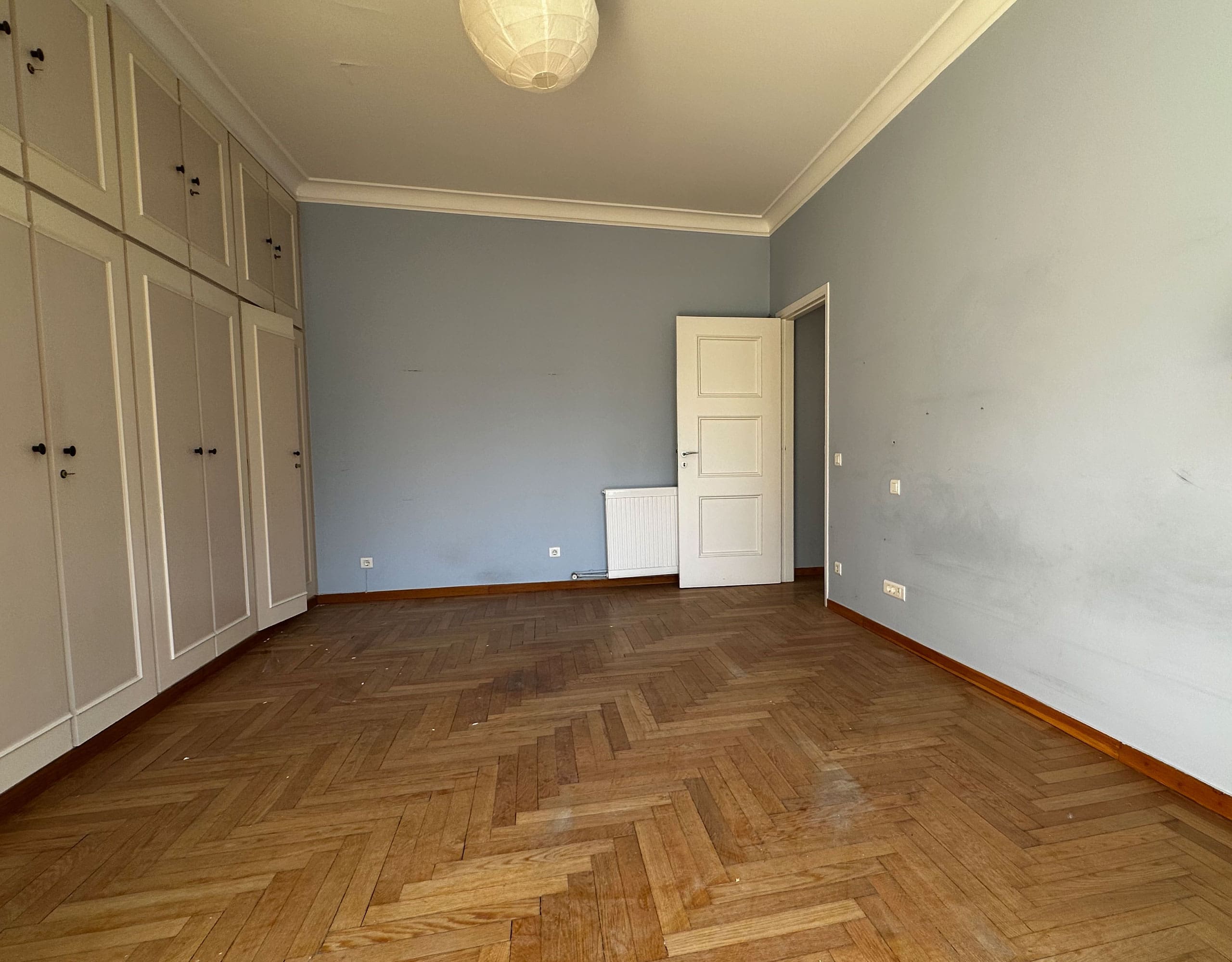 Empty room with wood flooring and built-in wardrobe doors, Anaktora, Kolonaki, Athens, Greece