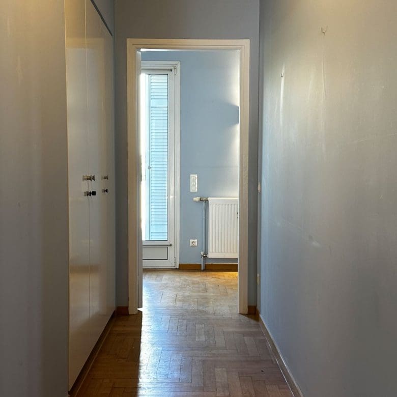 Hallway leading to a bathroom with wood flooring and natural light, Anaktora, Kolonaki, Athens, Greece