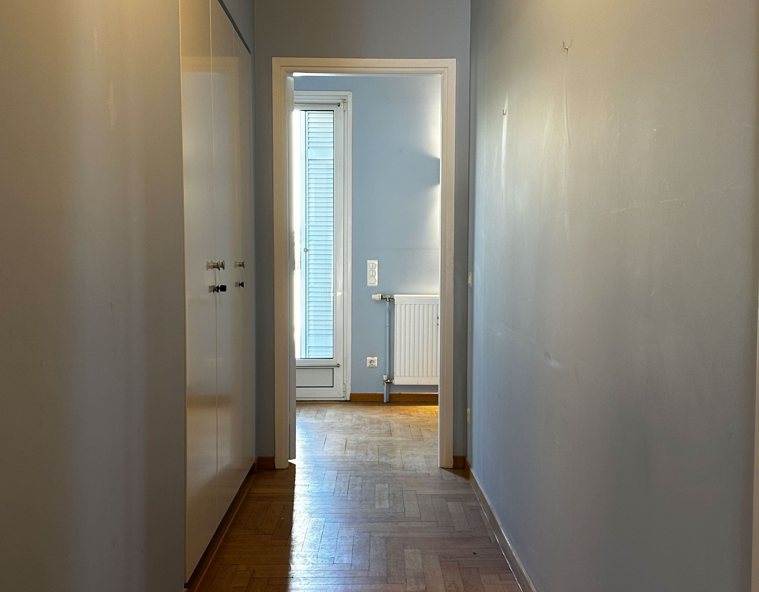 Hallway leading to a bathroom with wood flooring and natural light, Anaktora, Kolonaki, Athens, Greece