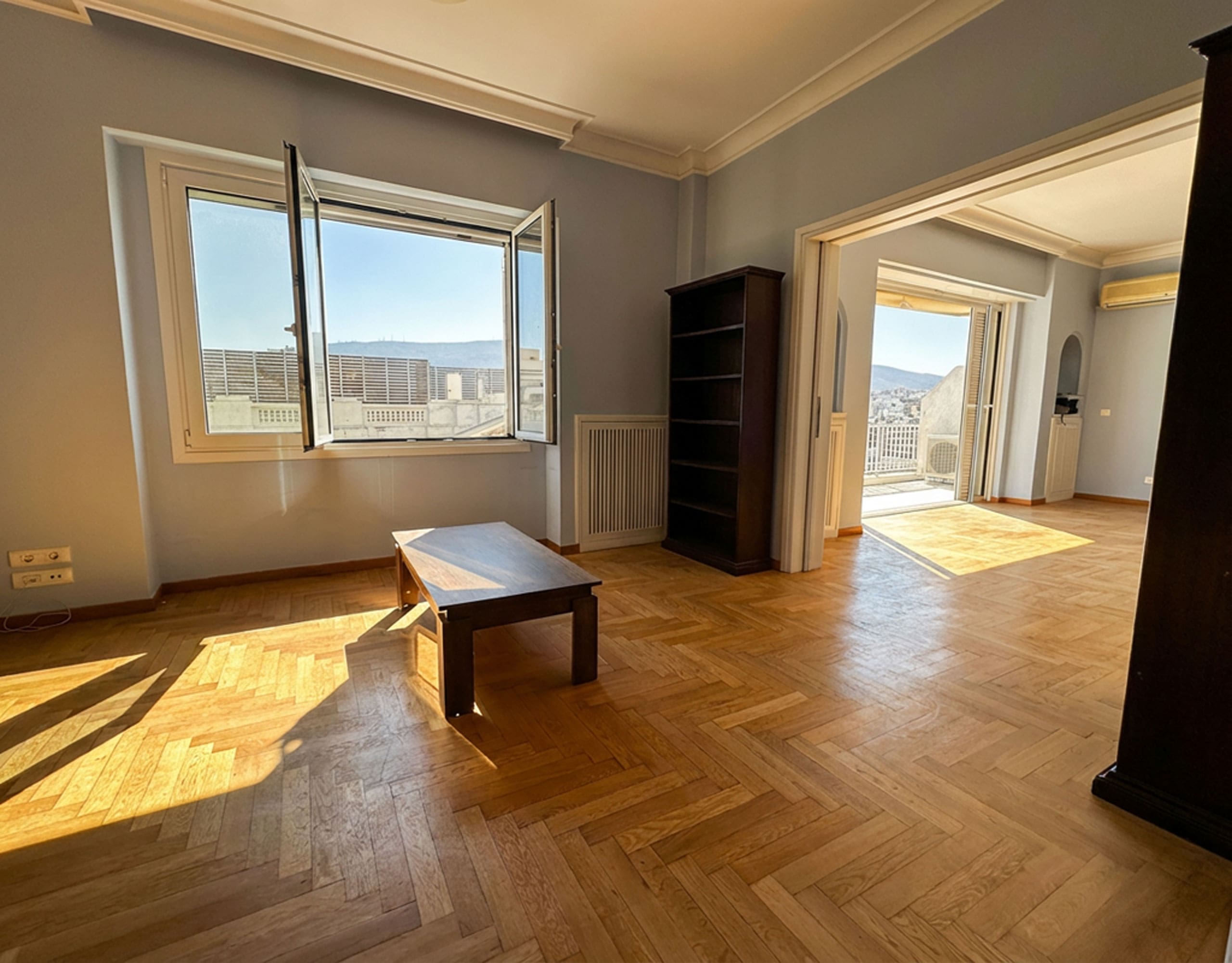 Bright room with wood flooring, window, and doorway to an adjacent room, Anaktora, Kolonaki, Athens, Greece
