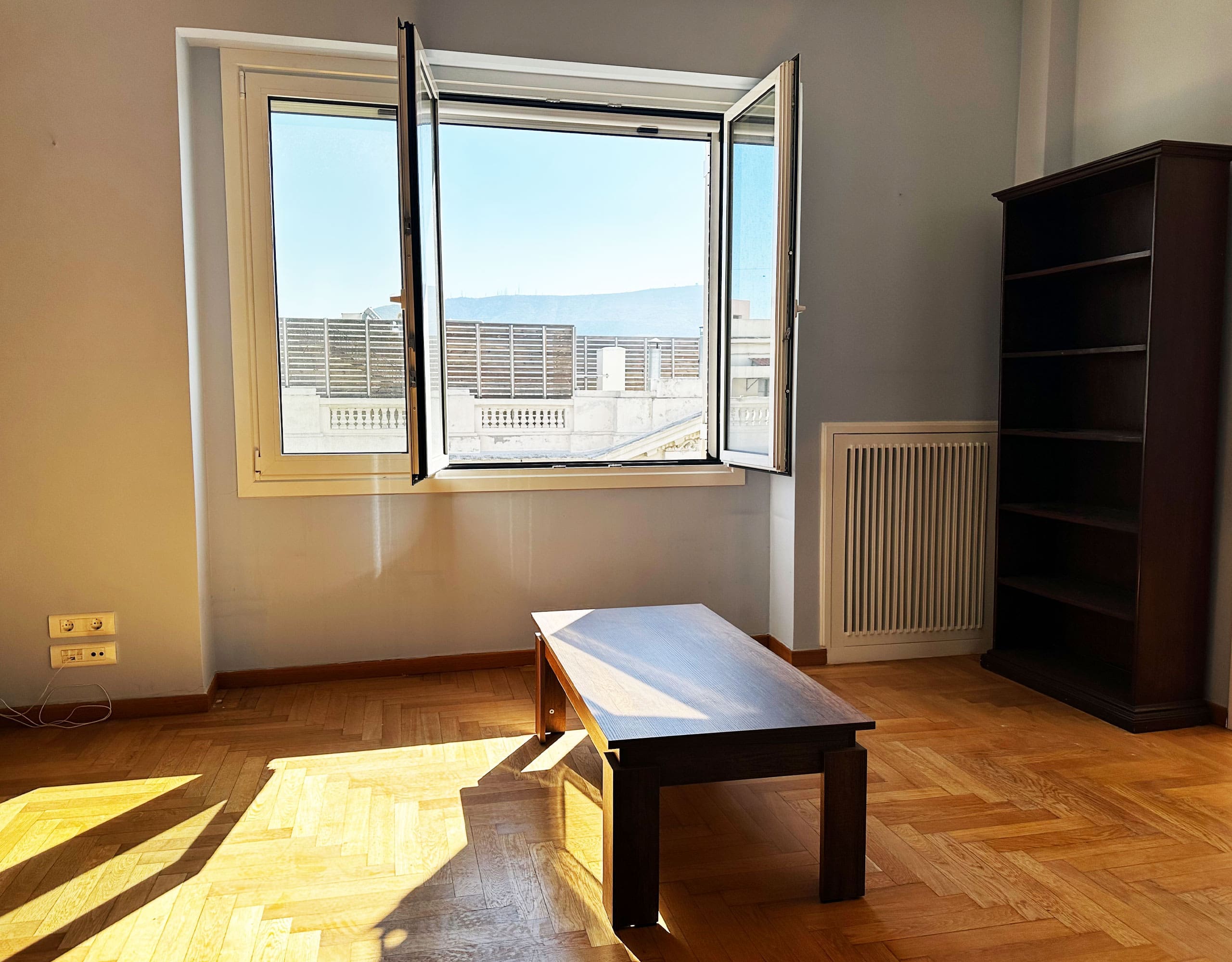 Bright room with wood flooring, open window, and city view, Anaktora, Kolonaki, Athens, Greece
