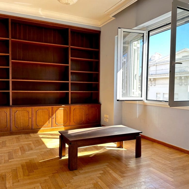 Room with built-in wall shelving, wood flooring, and open window, Anaktora, Kolonaki, Athens, Greece