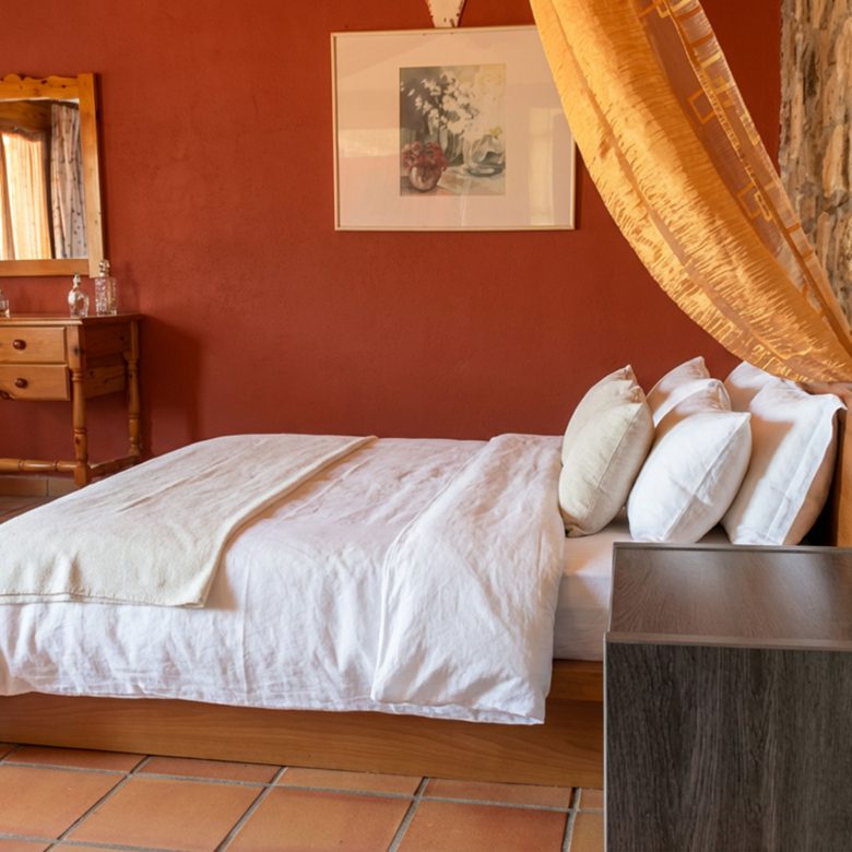 Lounge area with stone fireplace and bar counter in hotel property in Limi, Evia