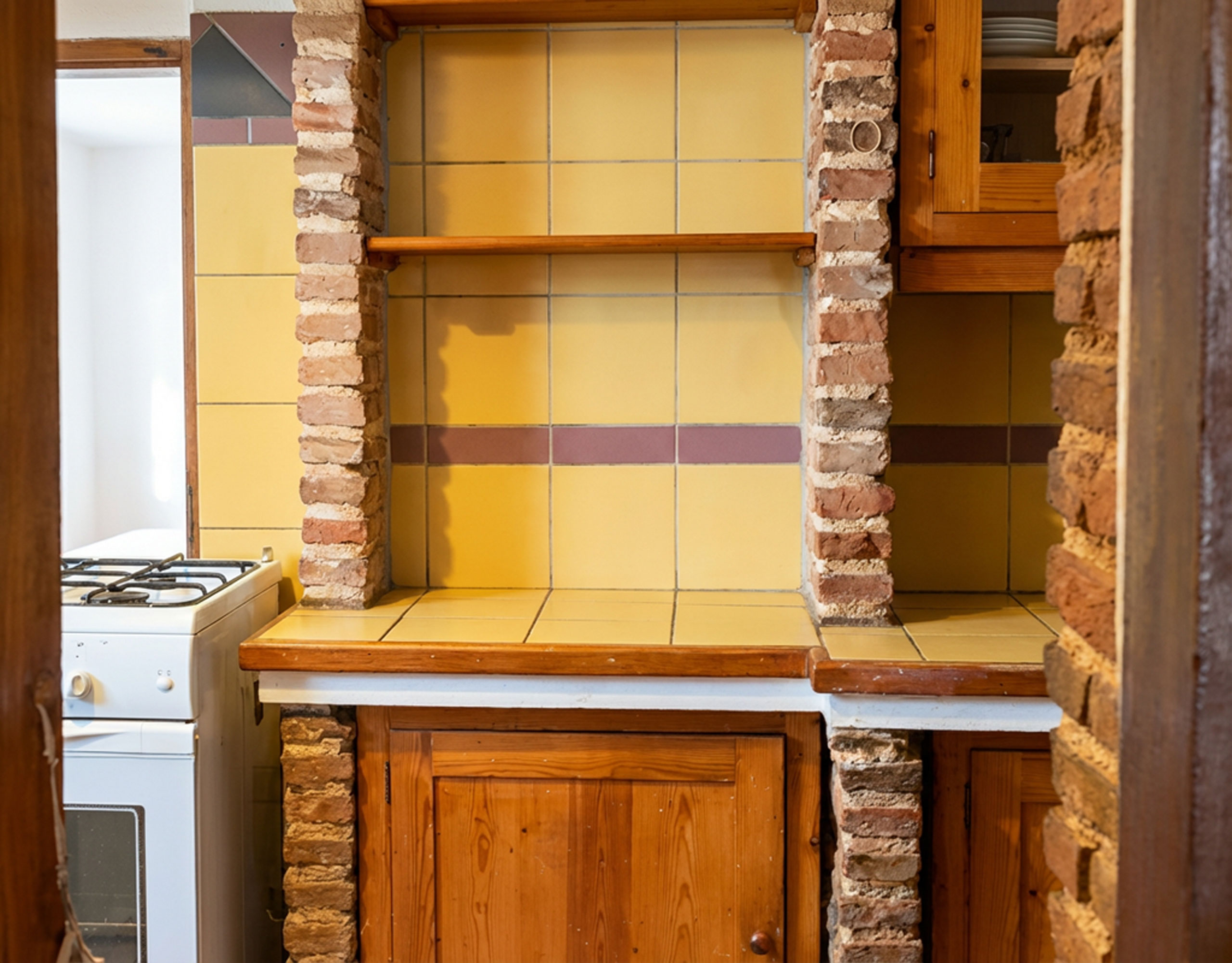 Kitchenette area with tiled backsplash and wooden cabinetry in hotel property in Limi, Evia