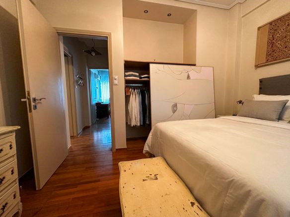 Bedroom view with parquet flooring and built-in wardrobe in Ampelokipoi renovated apartment