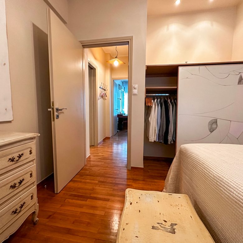 Bedroom with hallway view and built-in wardrobe in Ampelokipoi renovated apartment