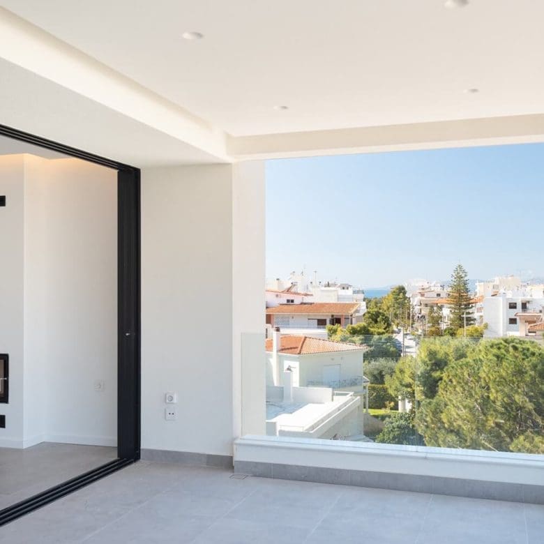 Modern living area with recessed ceiling and large opening to a balcony, Athens Riviera, Greece
