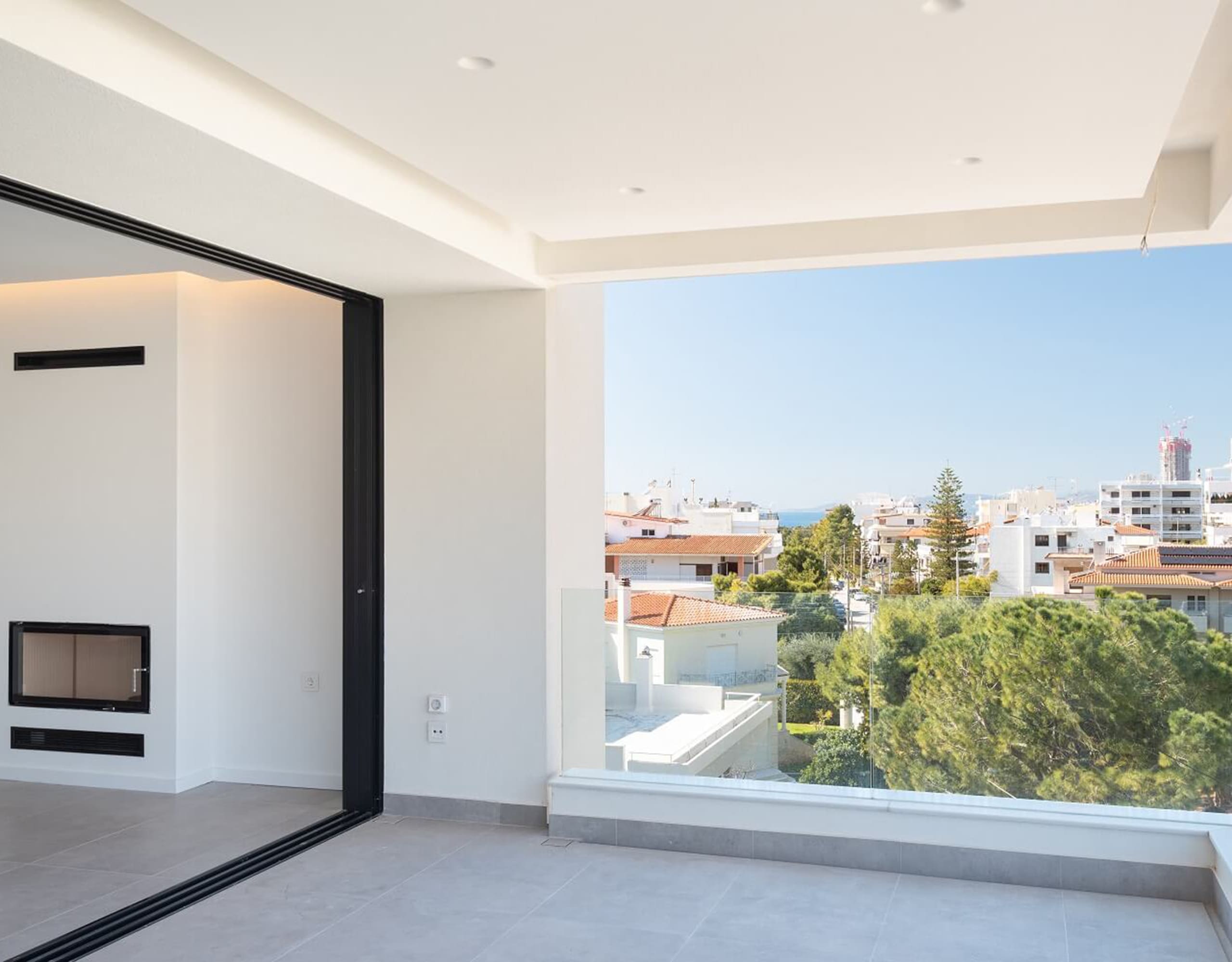 Modern living area with recessed ceiling and large opening to a balcony, Athens Riviera, Greece