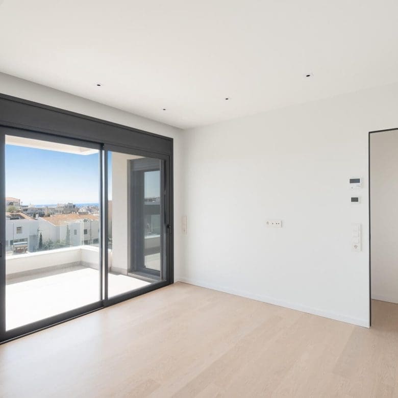 Bright modern room with large sliding doors opening to a balcony, Athens Riviera, Greece