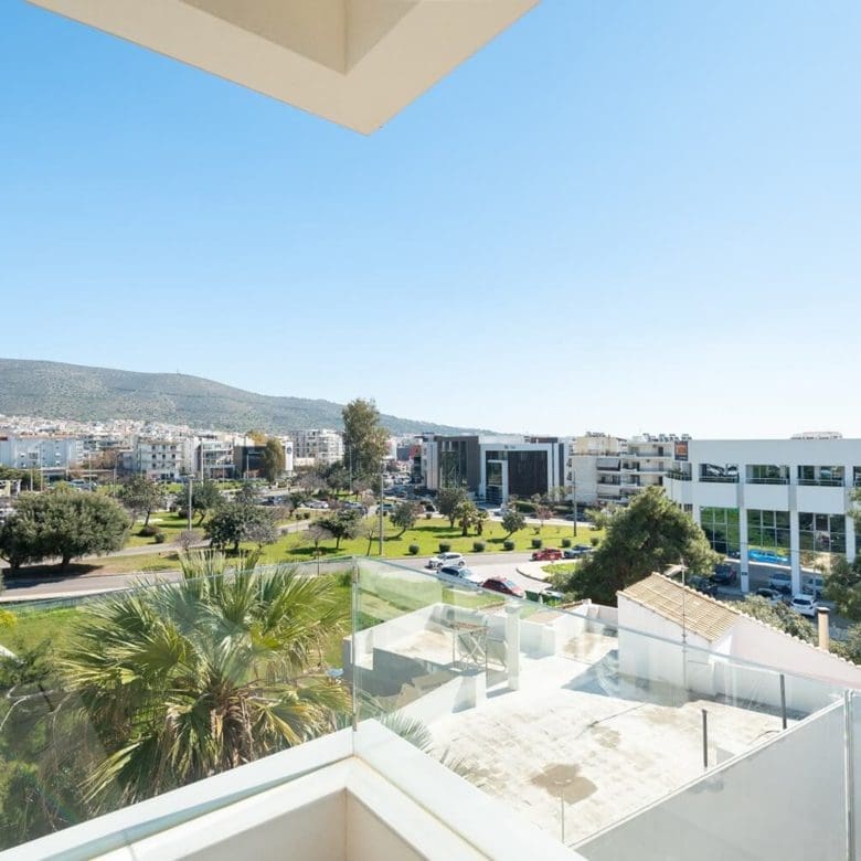 Balcony view over modern neighborhood with greenery and distant hills, Athens Riviera, Greece