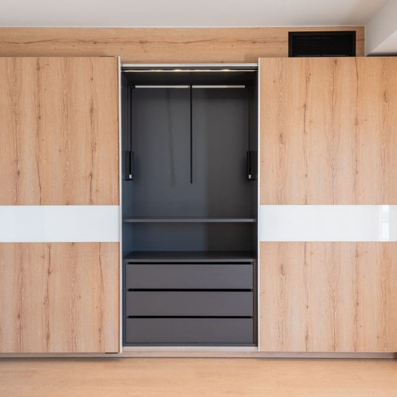 Built-in wood wardrobe wall with integrated storage and a central dark panel, Athens Riviera, Greece