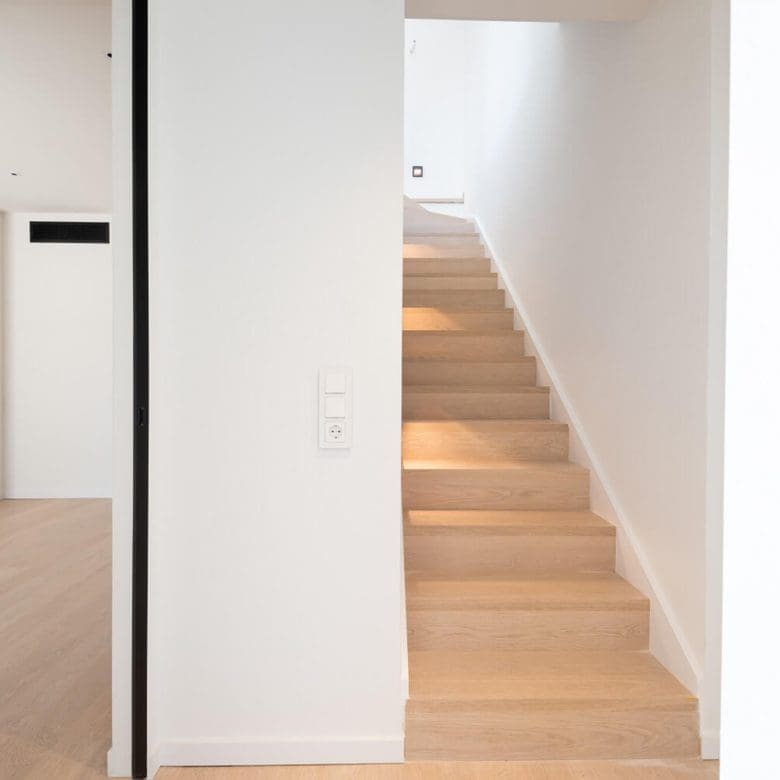 Interior hallway with wooden staircase and white walls, Athens Riviera, Greece