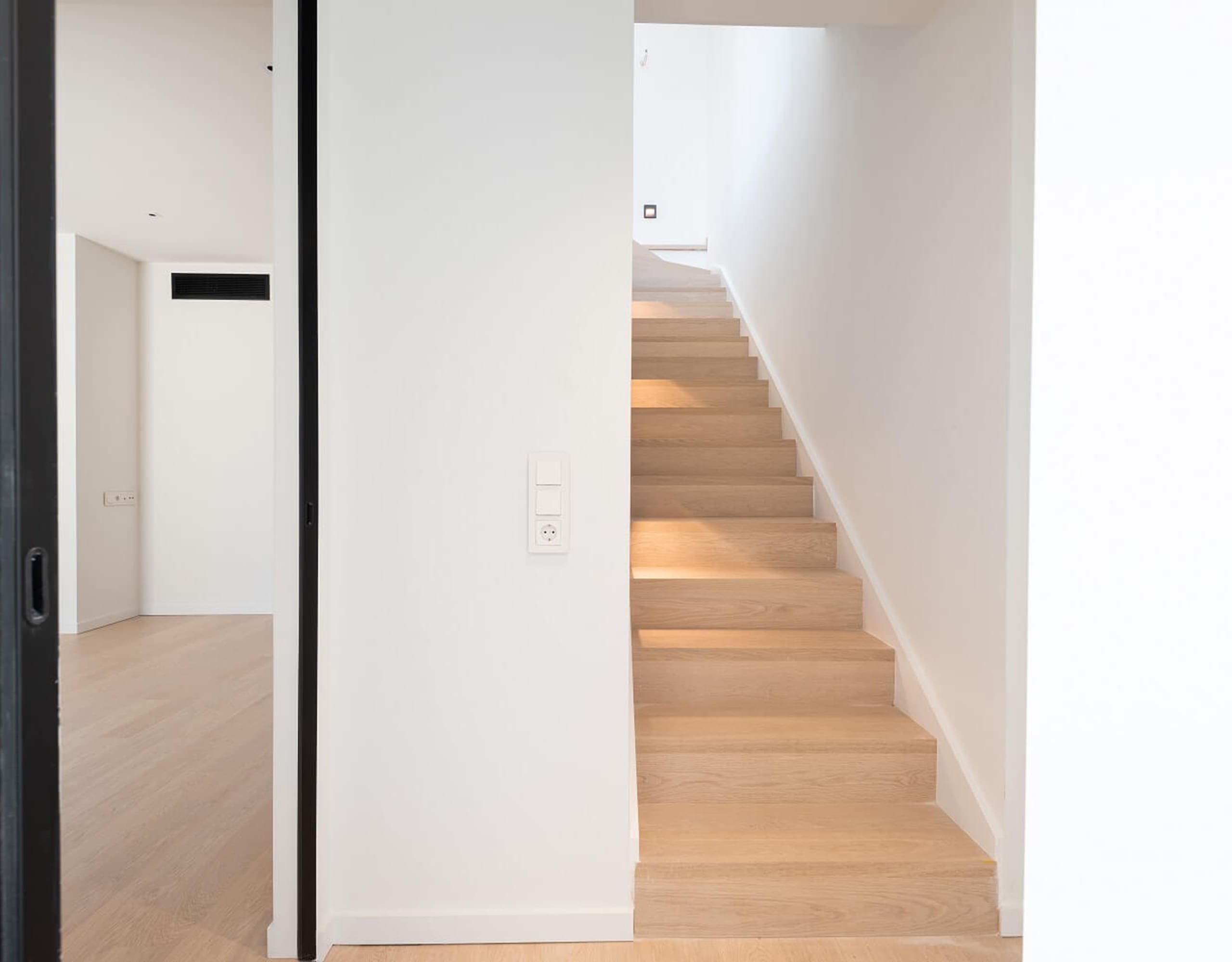Interior hallway with wooden staircase and white walls, Athens Riviera, Greece