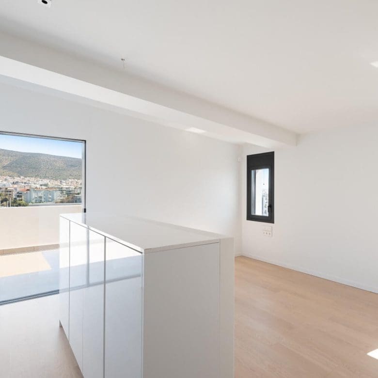 Bright upper-level landing with glass railing and large window, Athens Riviera, Greece