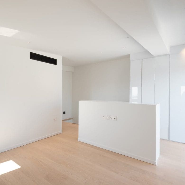 Bright open-plan living area with wood flooring and a central low partition, Athens Riviera, Greece