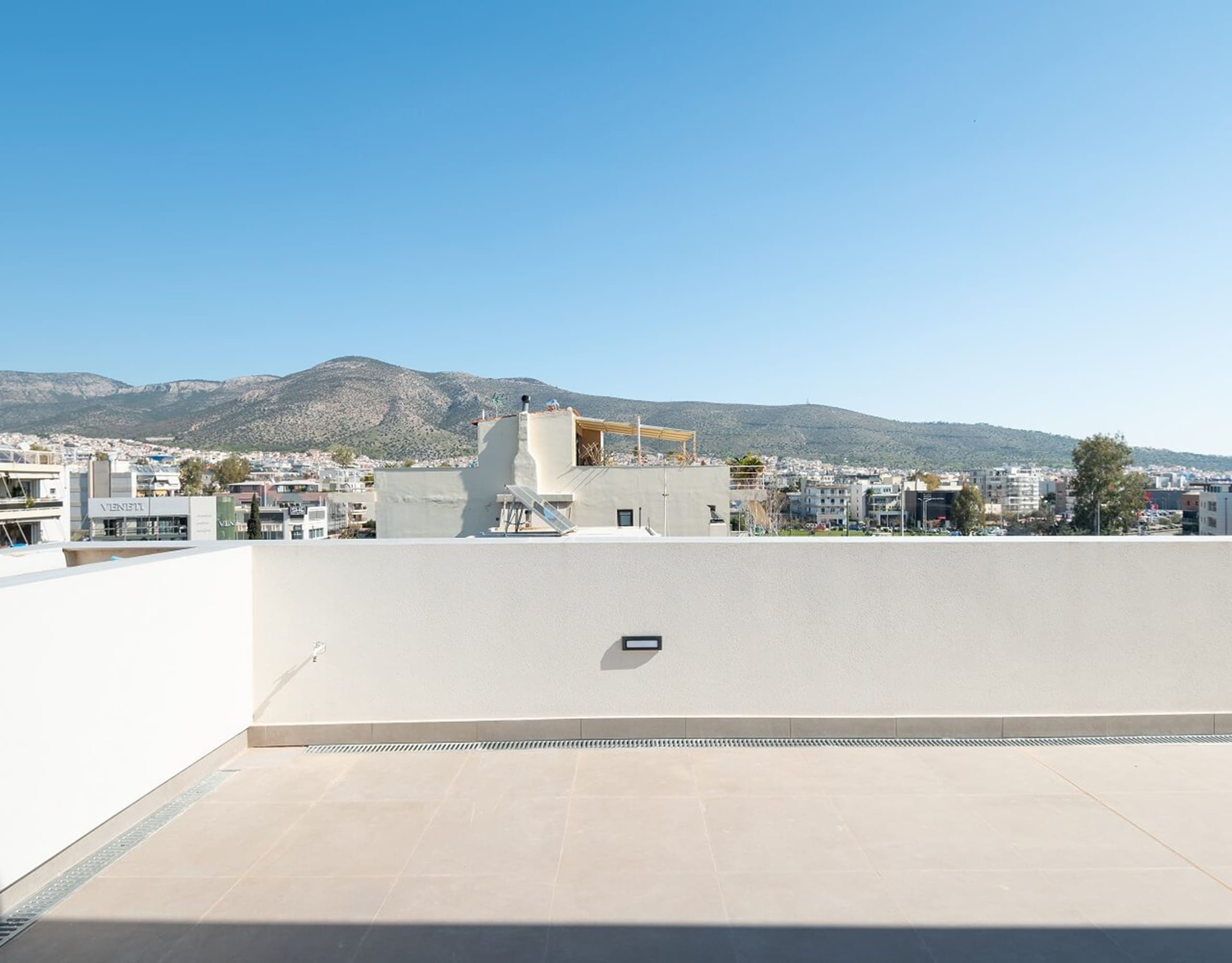 Spacious empty balcony terrace with open sky and mountain views, Athens Riviera, Greece