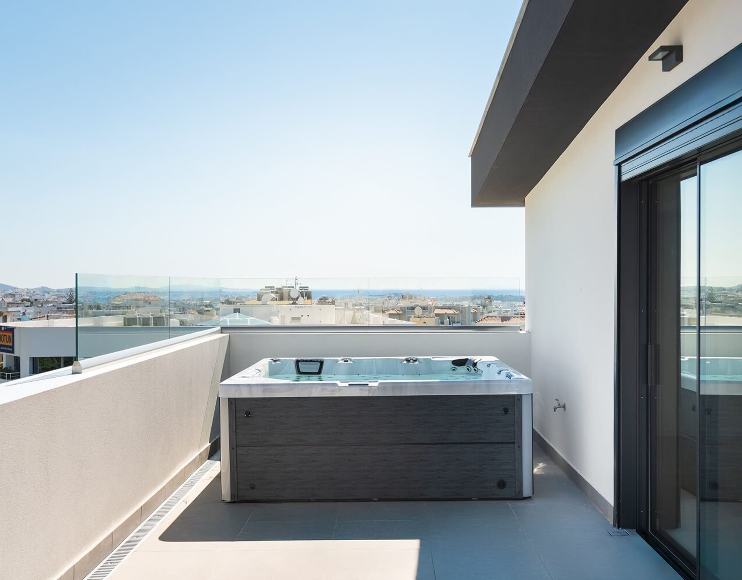 Rooftop terrace with built-in jacuzzi and open city-to-sea views, Athens Riviera, Greece