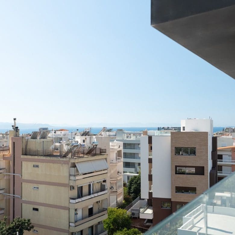 Elevated balcony view over the neighborhood with distant sea horizon, Athens Riviera, Greece