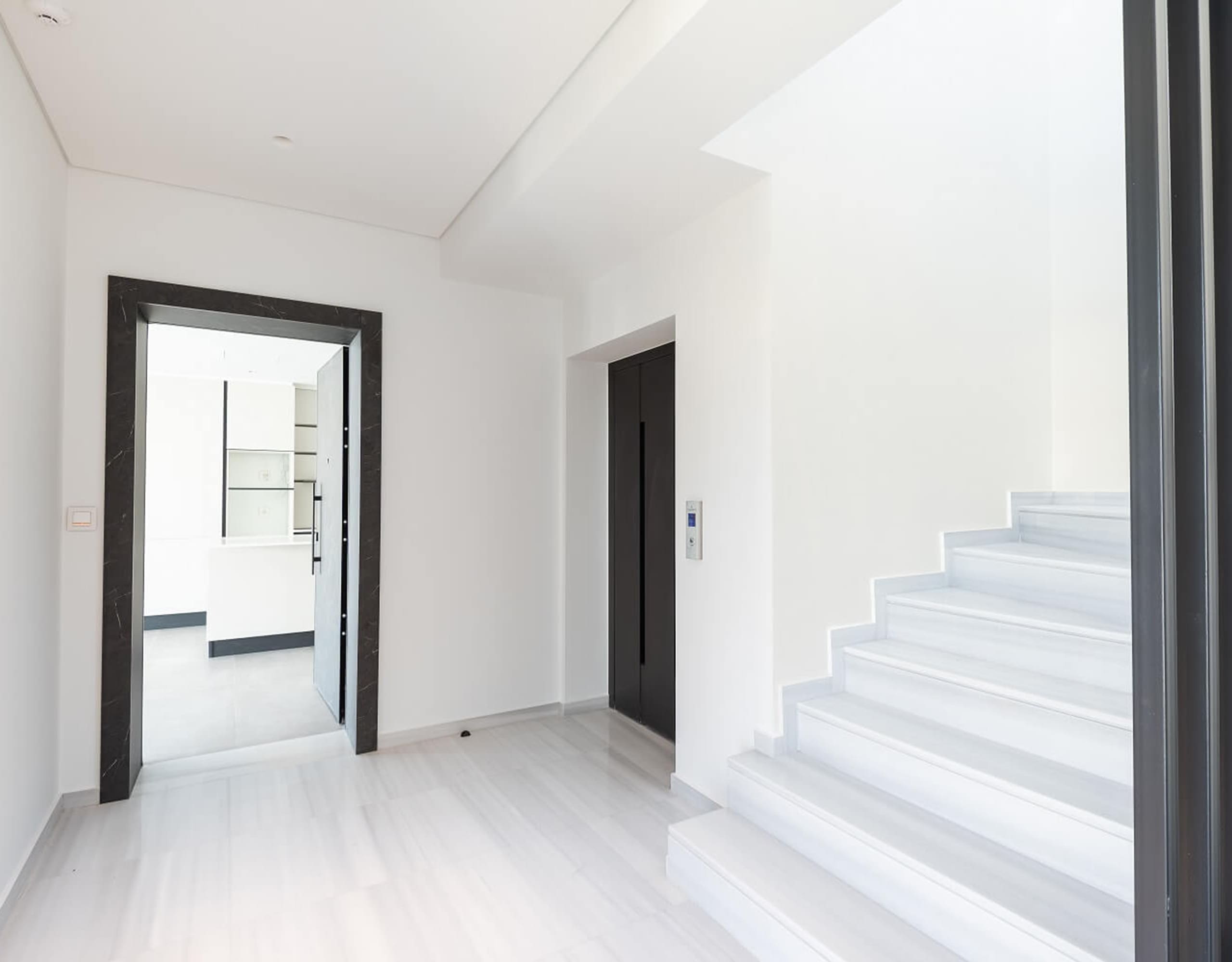 Bright interior stairwell with white steps and minimalist hallway, Athens Riviera, Greece