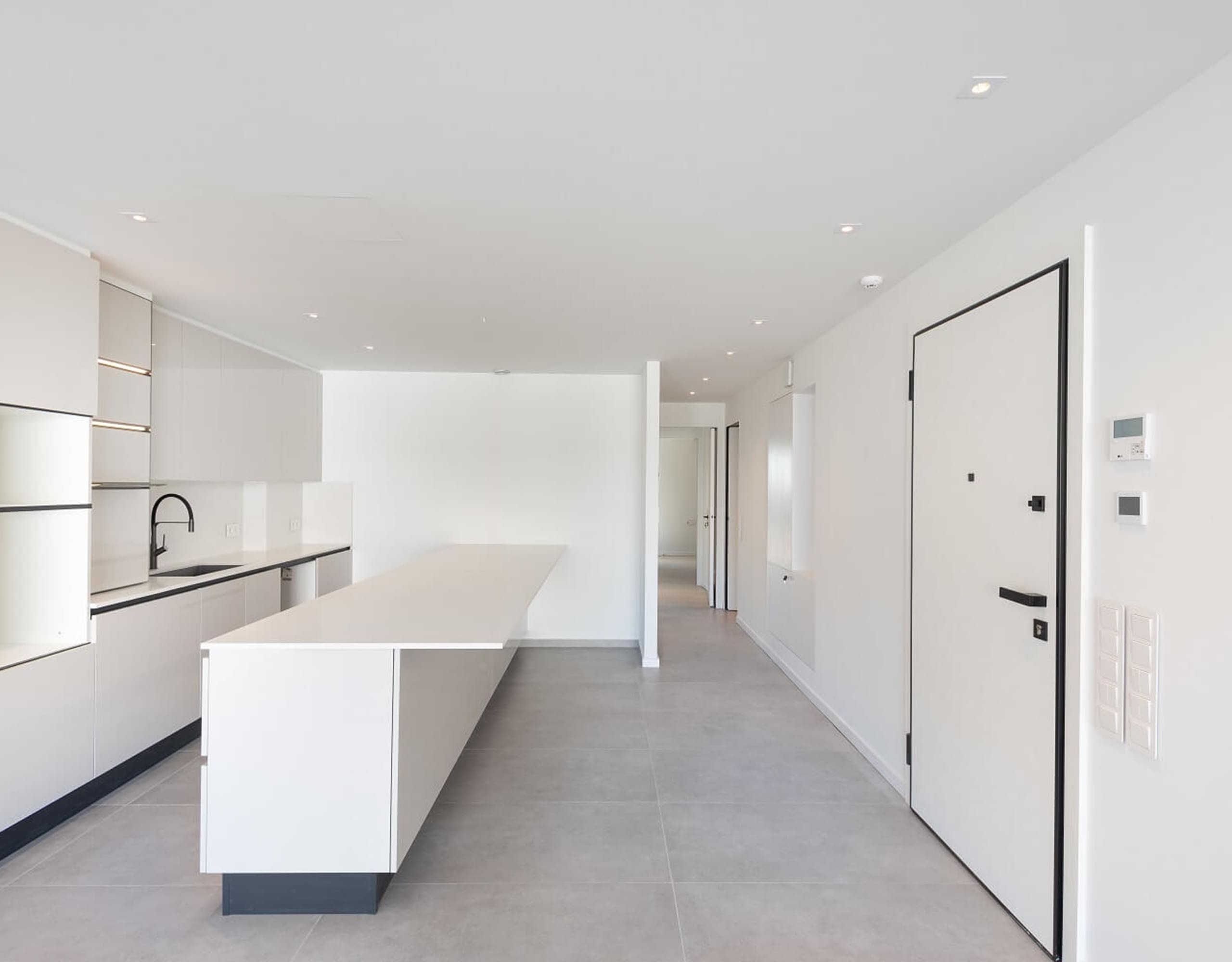 Minimal white kitchen with island and clean hallway lines, Athens Riviera, Greece