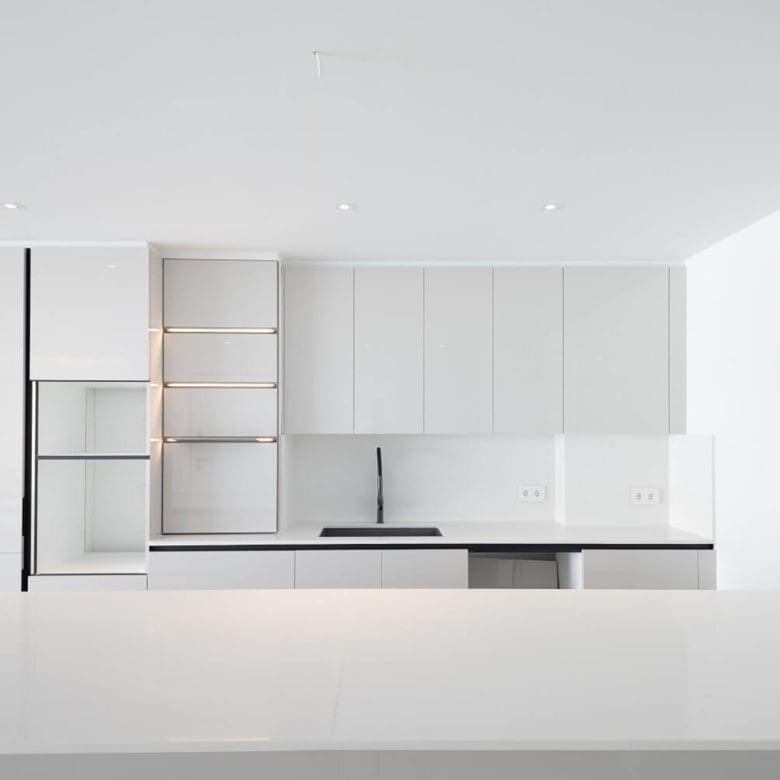 Built-in white kitchen cabinetry with open shelving detail, Athens Riviera, Greece