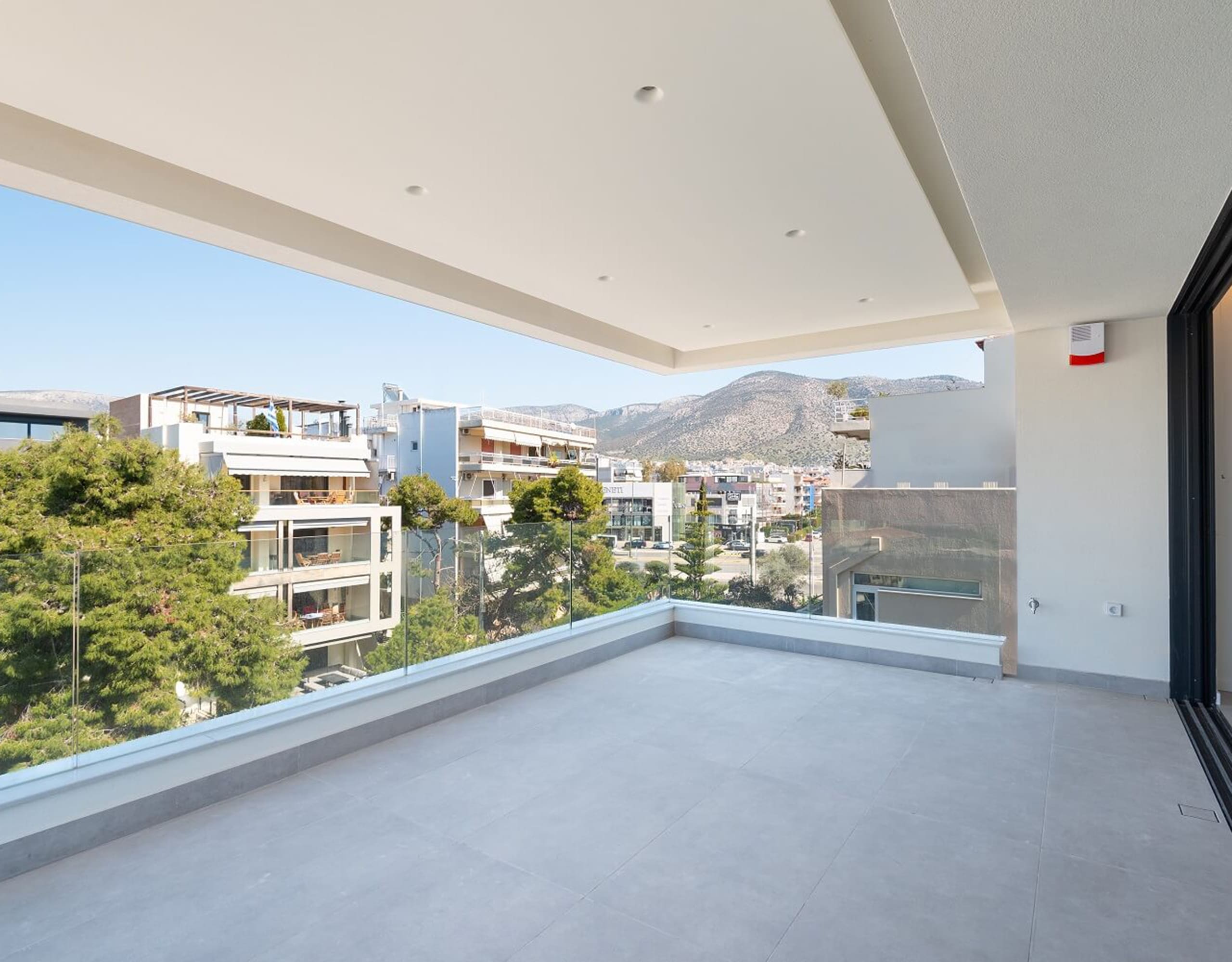Covered balcony with wide opening and open views to the surrounding area, Athens Riviera, Greece