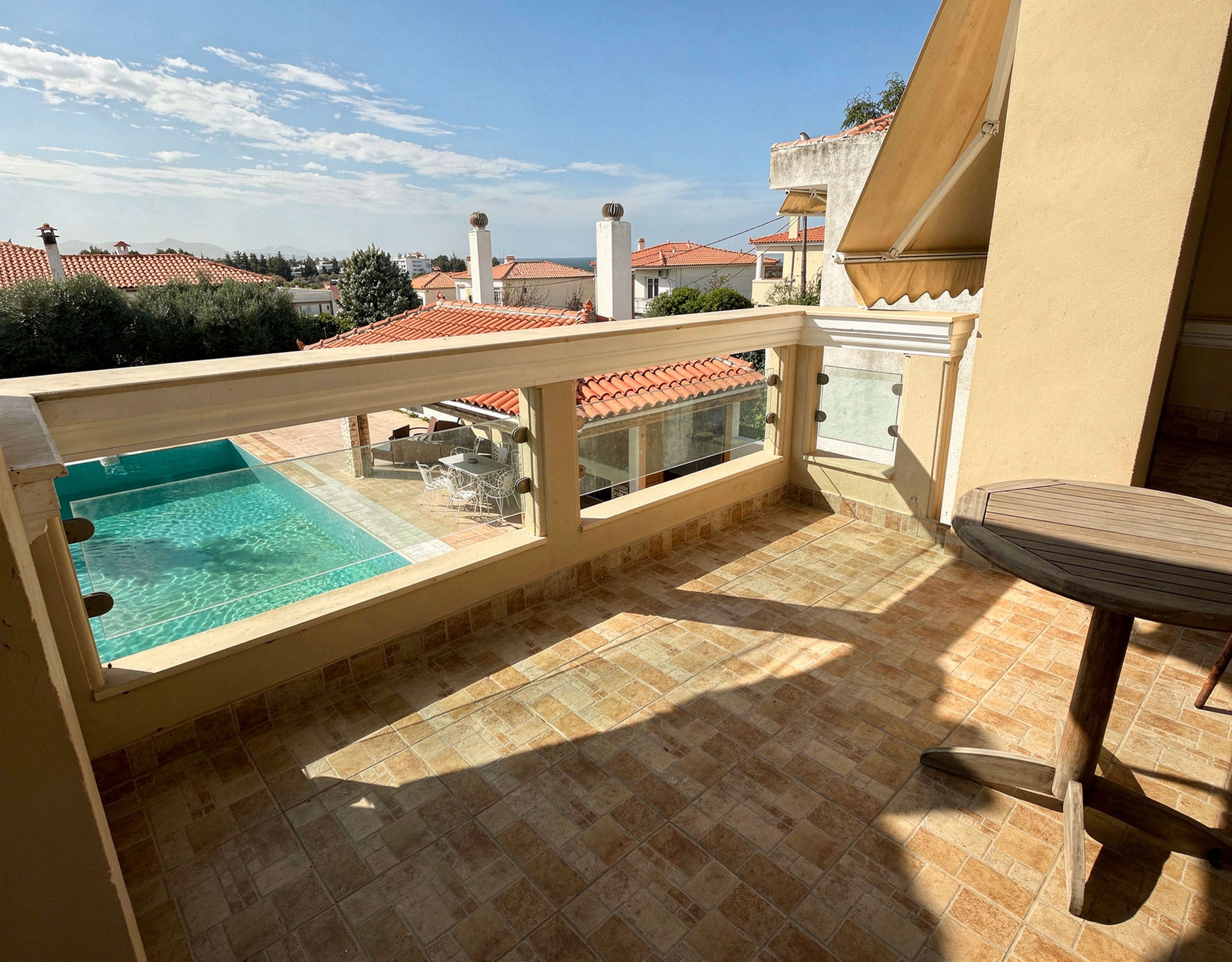Poolside Terrace — Outdoor Living Space Poolside terrace for outdoor dining and relaxation at the Eretria maisonette