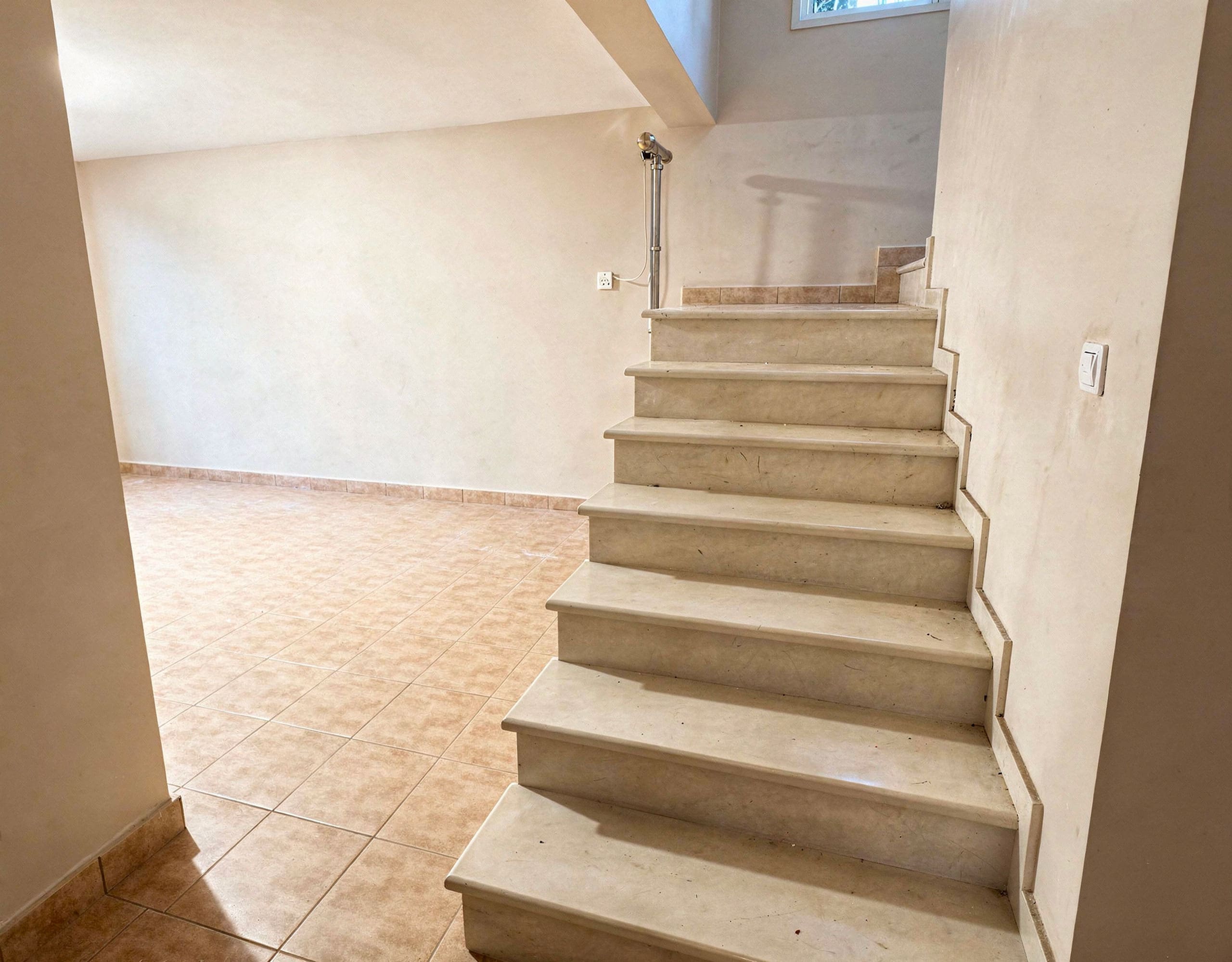 Detached Maisonette with Pool for Sale in Eretria28 Interior staircase connecting levels in the three-level maisonette in Eretria Title: Interior Staircase — Three-Level Maisonette