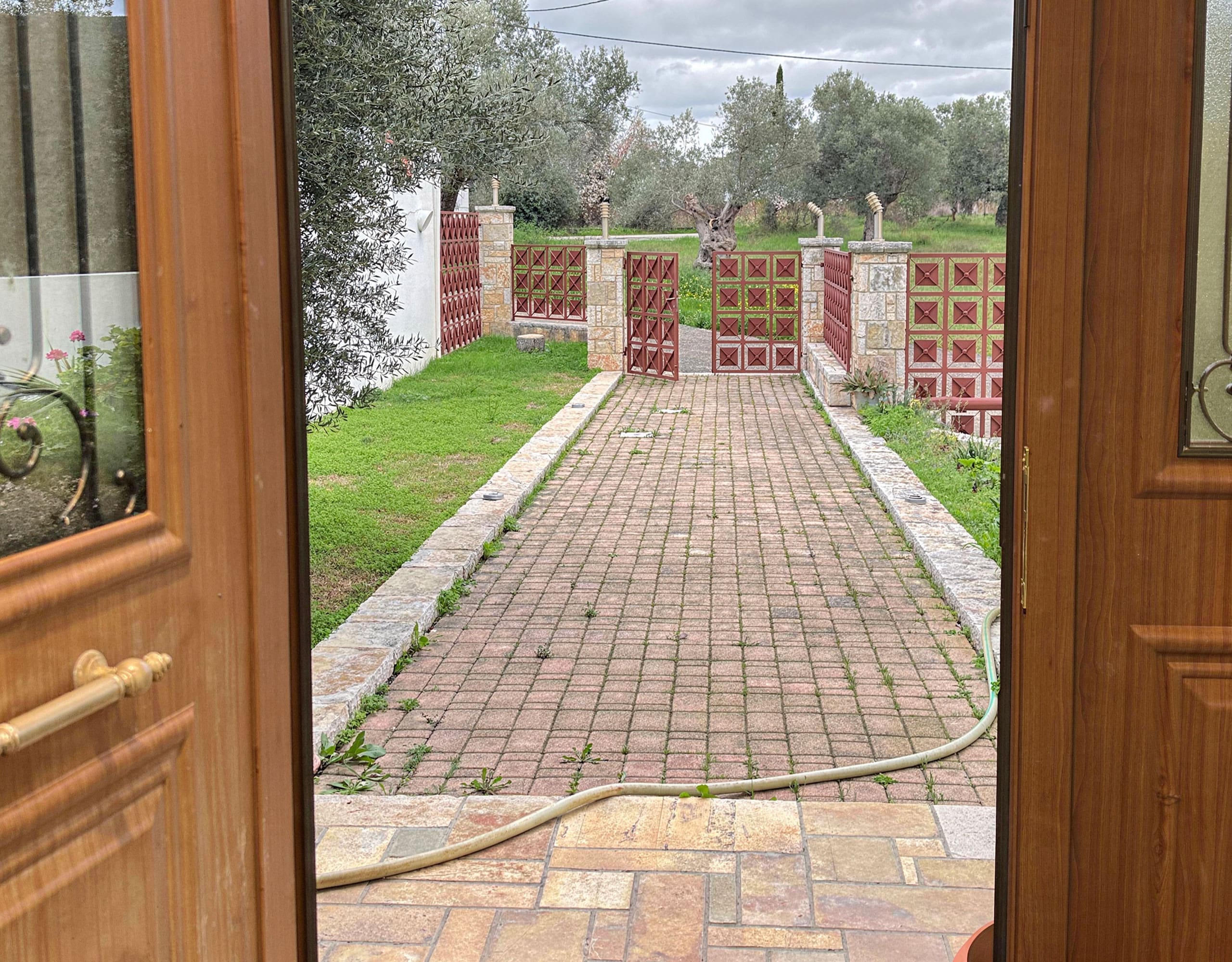 Driveway View from Indoors — Eretria Maisonette View of the driveway and entrance path from inside the maisonette in Eretria