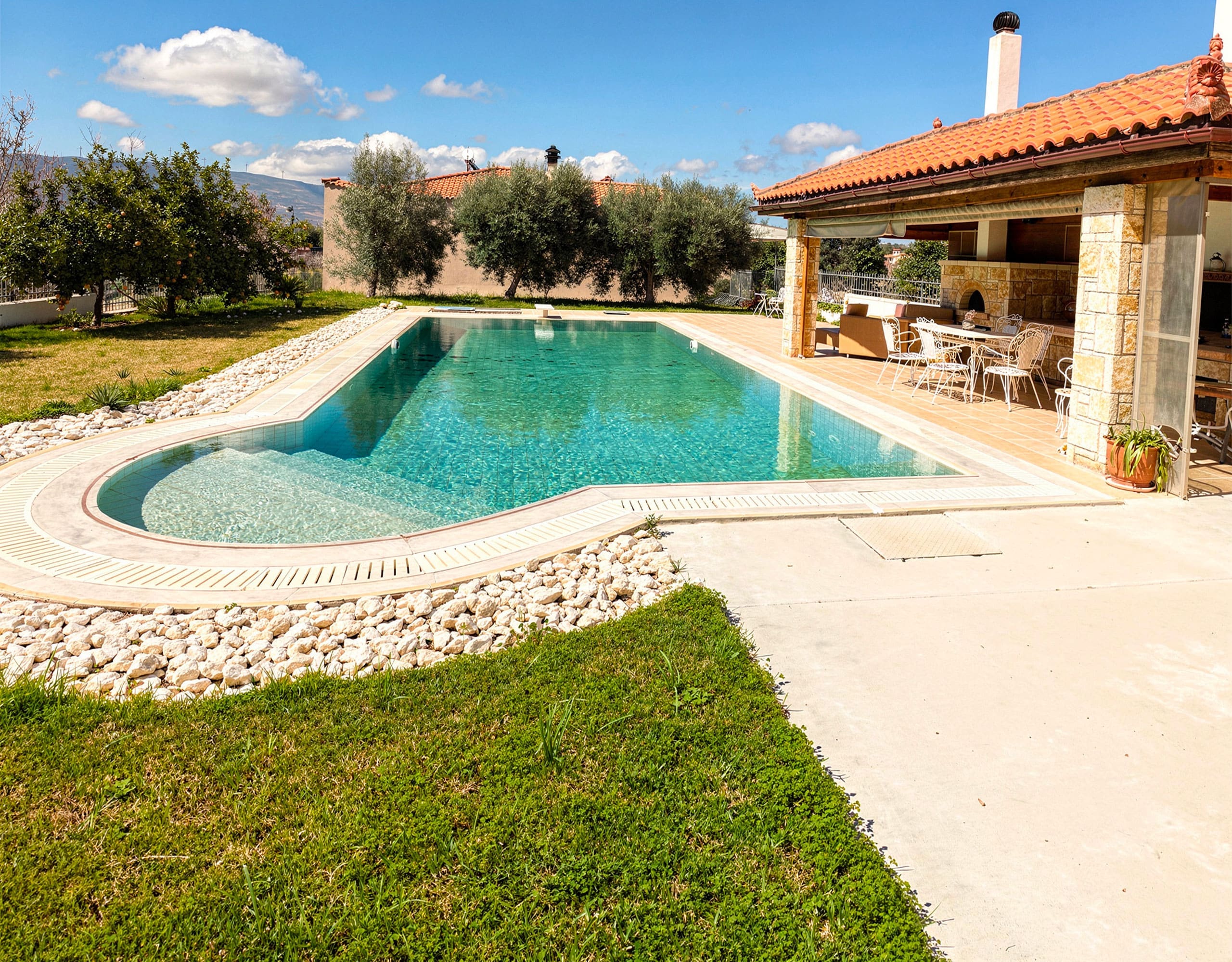 Shaded Poolside Seating — Eretria Maisonette Shaded outdoor seating next to the private pool at the Eretria maisonette