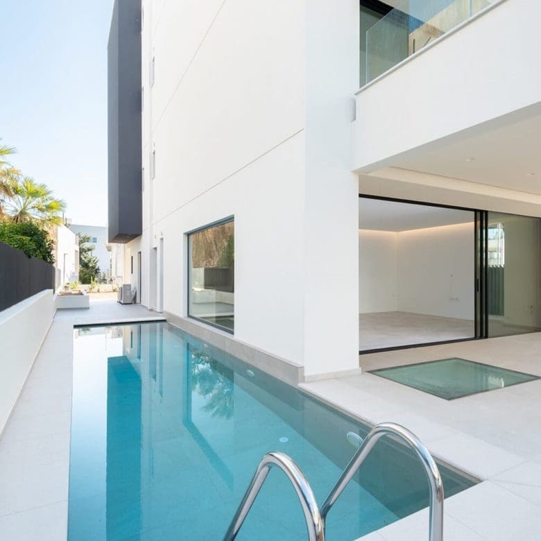 Narrow poolside corner with white modern villa facade and minimal deck, Athens Riviera, Greece