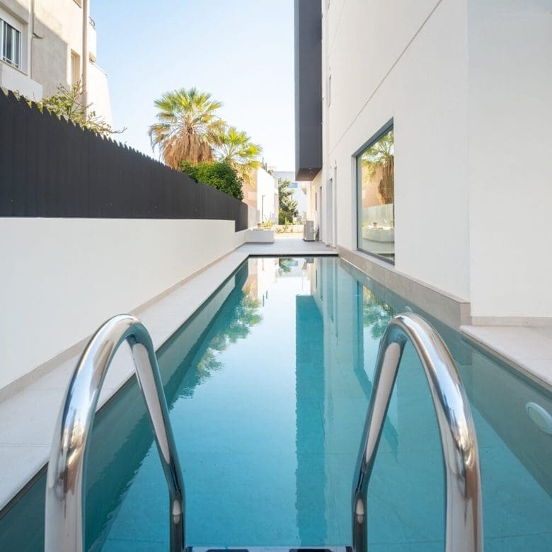 Swimming pool close-up with ladder at Glyfada Golf Luxury Residences, Athens Riviera