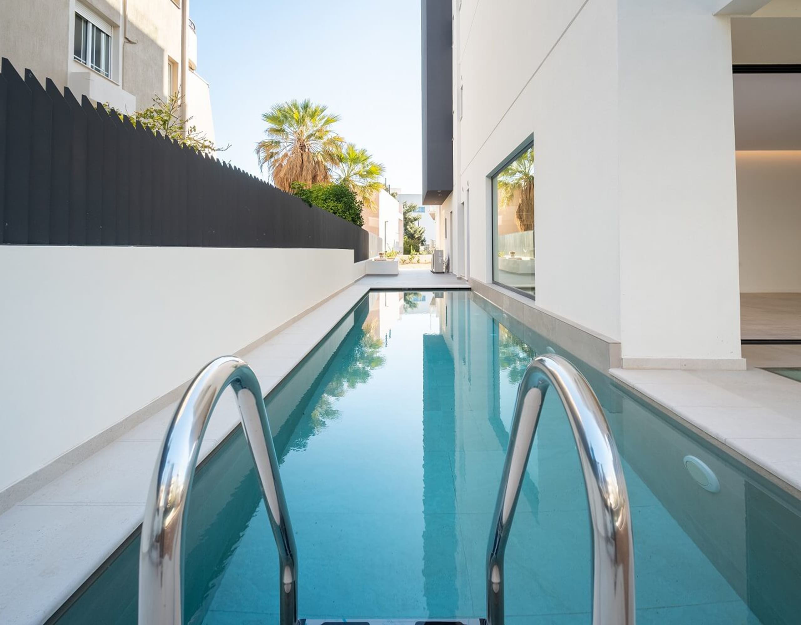 Swimming pool close-up with ladder at Glyfada Golf Luxury Residences, Athens Riviera